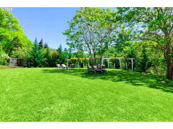 a view of house with backyard