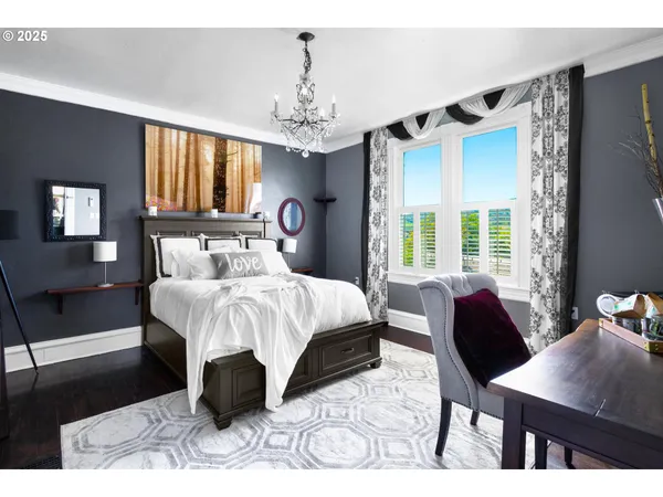 a bedroom with a bed mirror and window