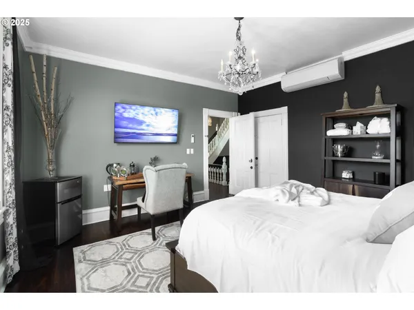 a bedroom with a bed and a chandelier