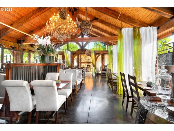 a dining room with wooden floor and outdoor view