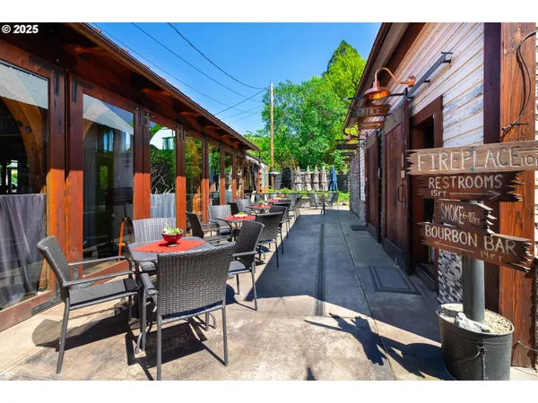 a view of a patio with table and chairs and potted plants