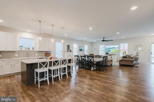 a kitchen with lots of wooden furniture and a dining table