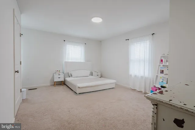 a bedroom with a bed and a gym equipment