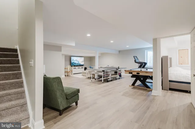 a living room with furniture and a dining table with chair