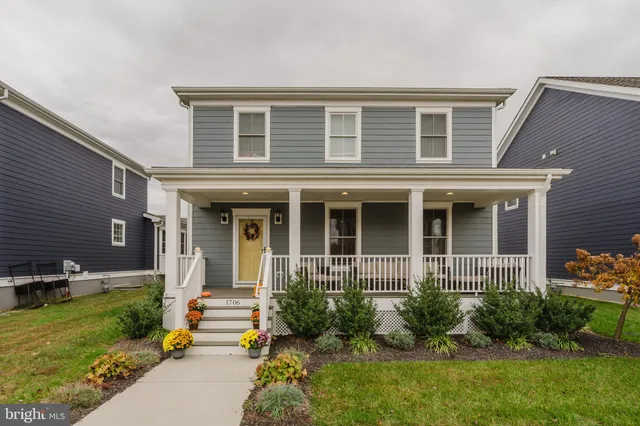 a front view of a house with garden and porch