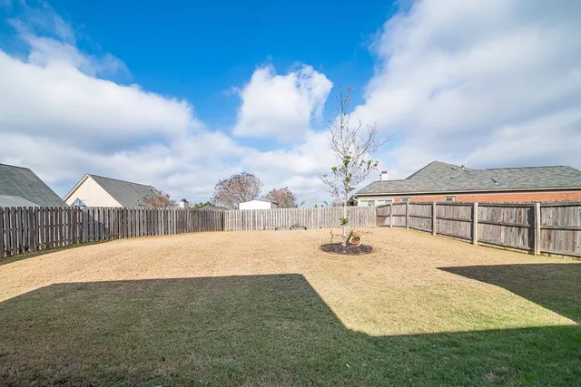 a view of a house with backyard and porch