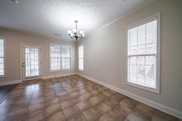 a view of empty room with wooden floor and window