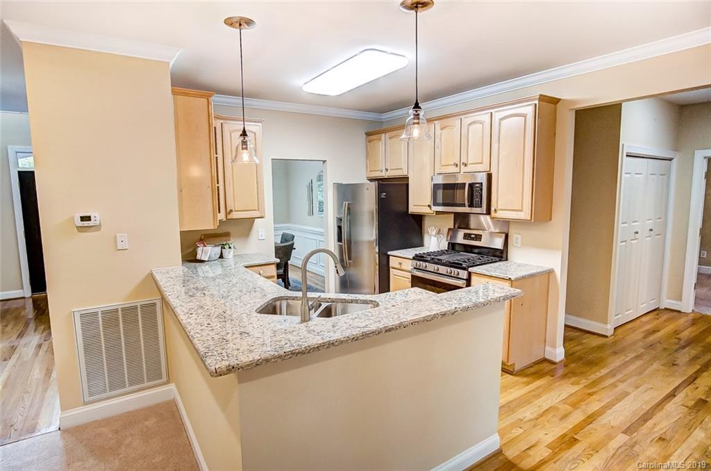 11121 Windgate Court Tega Cay, SC 29708 - Photo 15 of 44 a kitchen with stainless steel appliances granite countertop a sink refrigerator and microwave