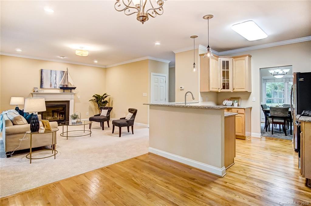 11121 Windgate Court Tega Cay, SC 29708 - Photo 20 of 44 a living room with stainless steel appliances kitchen island granite countertop furniture and a kitchen view