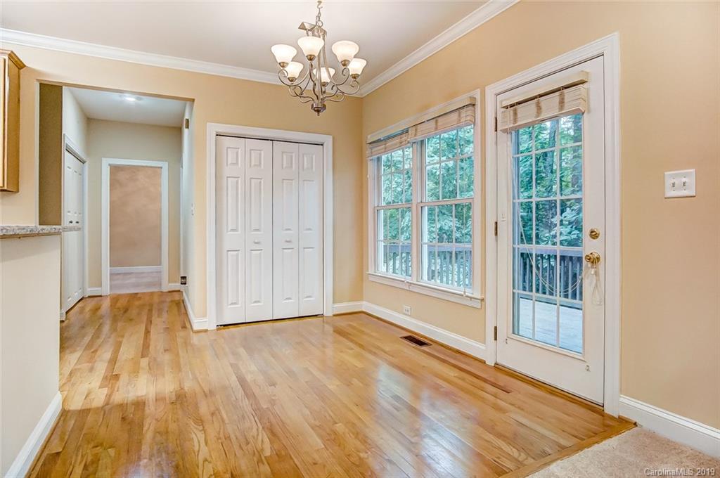 11121 Windgate Court Tega Cay, SC 29708 - Photo 21 of 44 a view of an empty room with wooden floor and a window