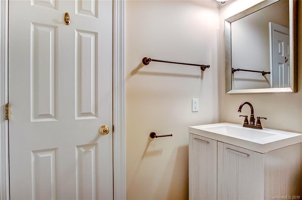 11121 Windgate Court Tega Cay, SC 29708 - Photo 24 of 44 a bathroom with a sink and a mirror