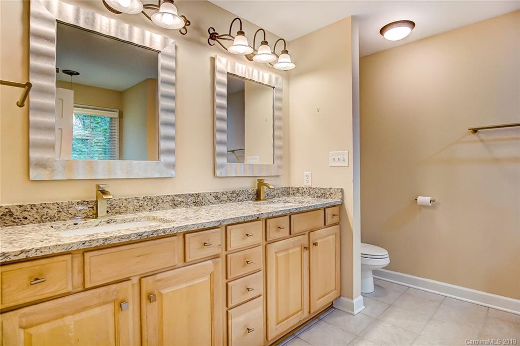 11121 Windgate Court Tega Cay, SC 29708 - Photo 30 of 44 a bathroom with a granite countertop sink and a mirror