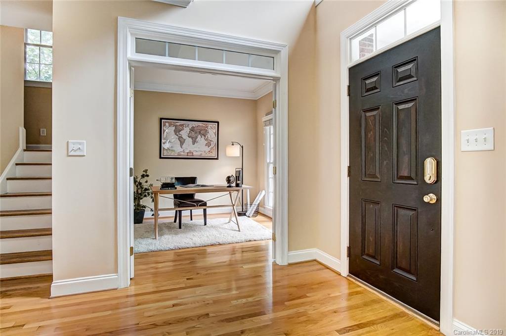 11121 Windgate Court Tega Cay, SC 29708 - Photo 4 of 44 a view of a hallway to a livingroom with furniture and wooden floor