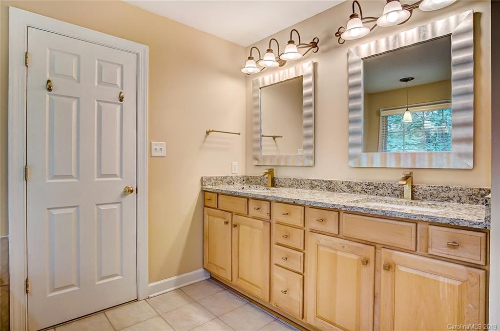 11121 Windgate Court Tega Cay, SC 29708 - Photo 31 of 44 a bathroom with a granite countertop sink and a mirror