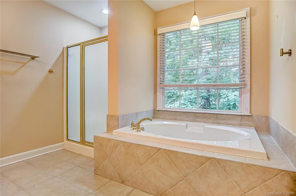 11121 Windgate Court Tega Cay, SC 29708 - Photo 32 of 44 a spacious bathroom with bathtub and shower