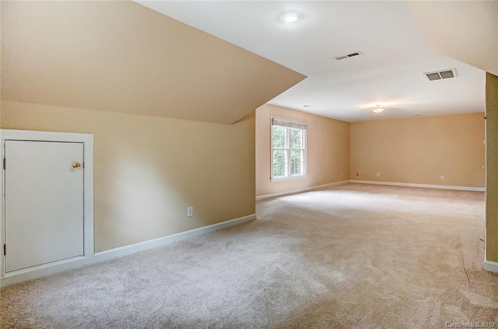 11121 Windgate Court Tega Cay, SC 29708 - Photo 39 of 44 an empty room with windows