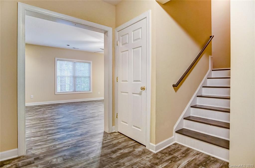 11121 Windgate Court Tega Cay, SC 29708 - Photo 40 of 44 a view of entryway with wooden floor and stairs