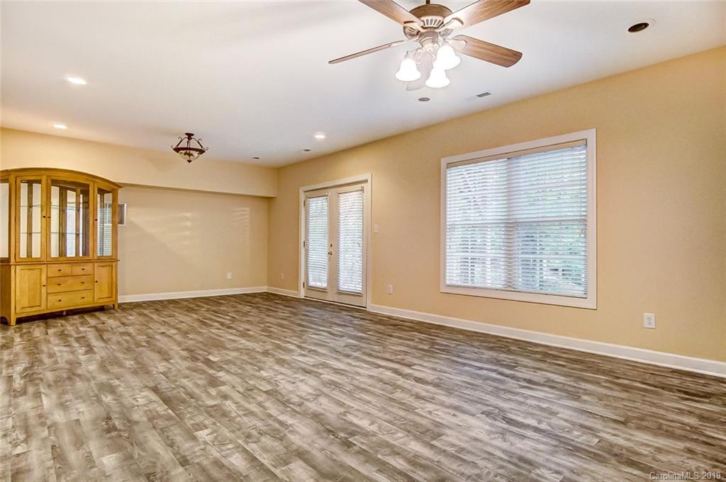 11121 Windgate Court Tega Cay, SC 29708 - Photo 41 of 44 a view of an empty room with a window and wooden floor