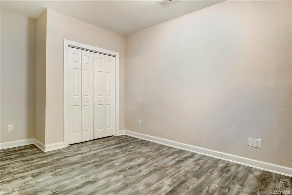 11121 Windgate Court Tega Cay, SC 29708 - Photo 42 of 44 an empty room with wooden floor and closet