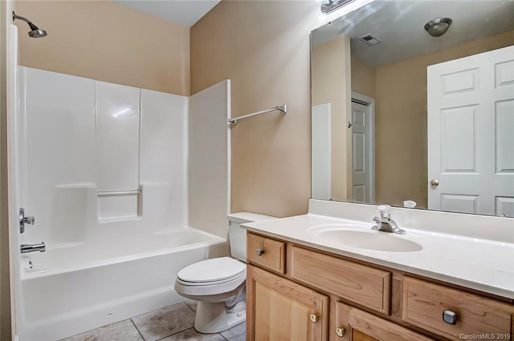 11121 Windgate Court Tega Cay, SC 29708 - Photo 43 of 44 a bathroom with a sink a toilet and a bathtub