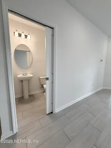 a bathroom with a toilet a sink and a mirror