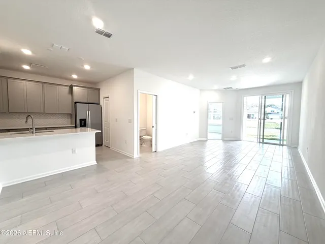 a view of a kitchen with a sink and cabinets