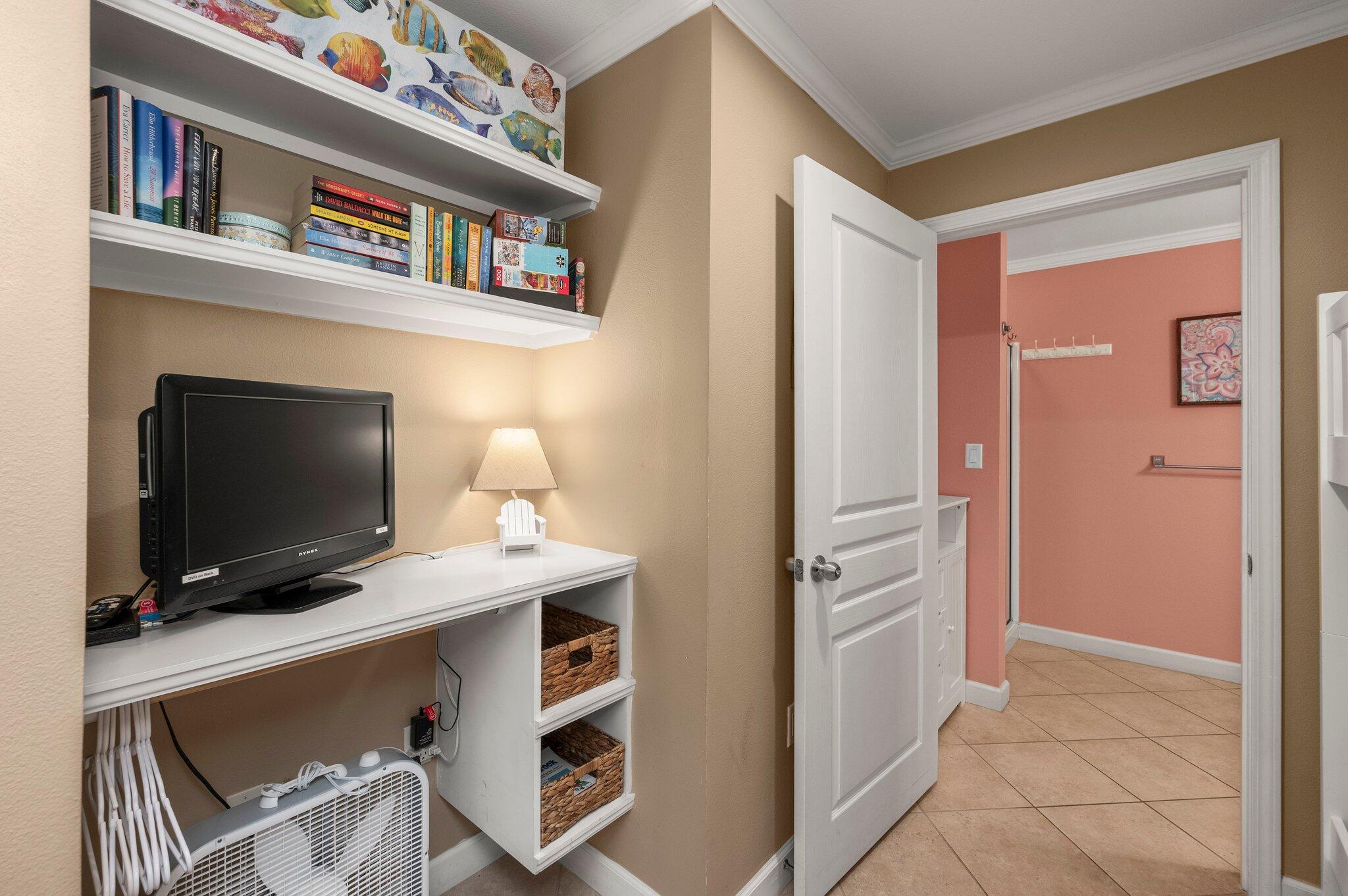 548 Sandy Cay Drive, Unit 203 Miramar Beach, FL 32550 - Photo 11 of 48 a room with a flat screen tv and a refrigerator