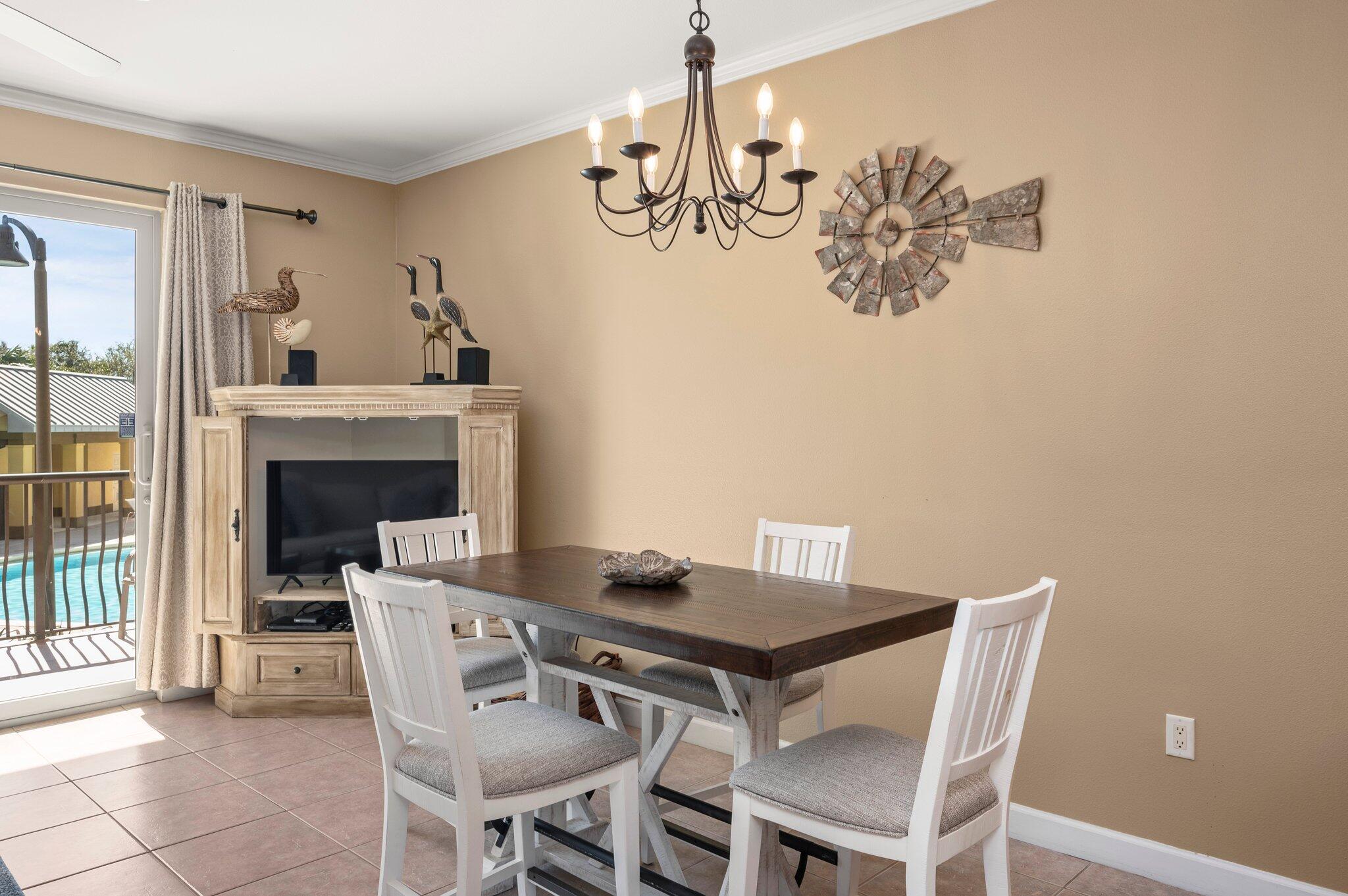 548 Sandy Cay Drive, Unit 203 Miramar Beach, FL 32550 - Photo 22 of 48 a view of a dining room with furniture and chandelier