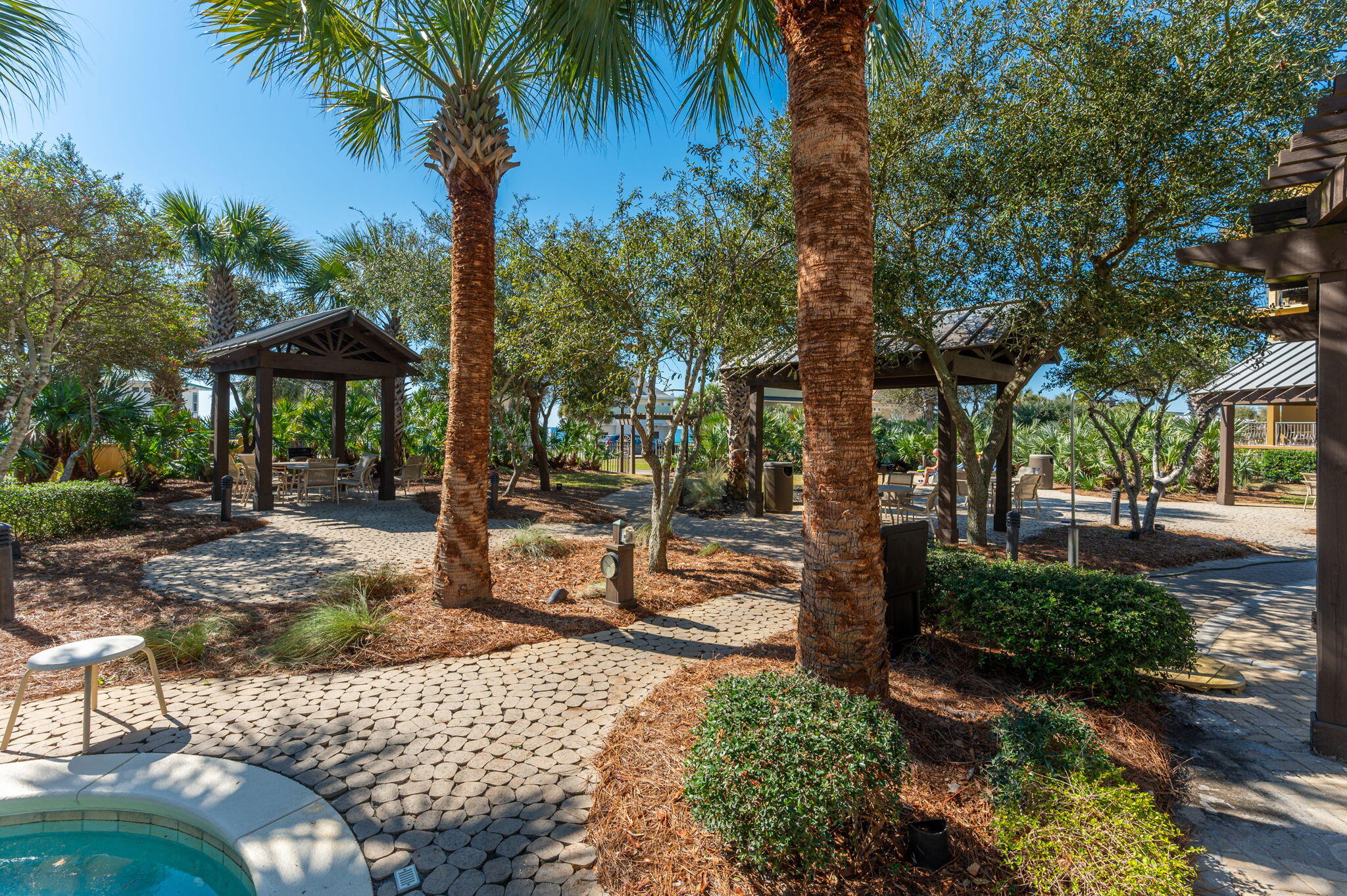 548 Sandy Cay Drive, Unit 203 Miramar Beach, FL 32550 - Photo 28 of 48 a view of a patio with a table and chairs under an umbrella