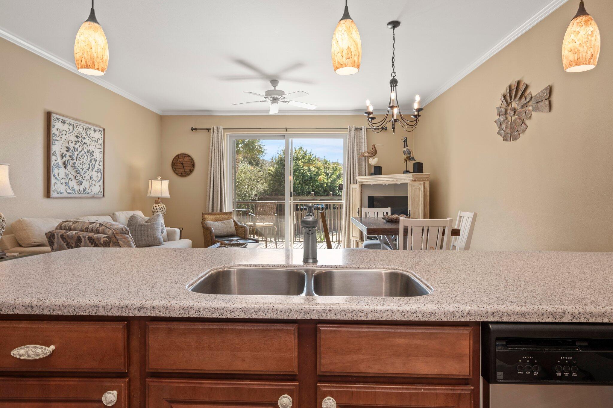 548 Sandy Cay Drive, Unit 203 Miramar Beach, FL 32550 - Photo 36 of 48 a kitchen with granite countertop a sink and cabinets