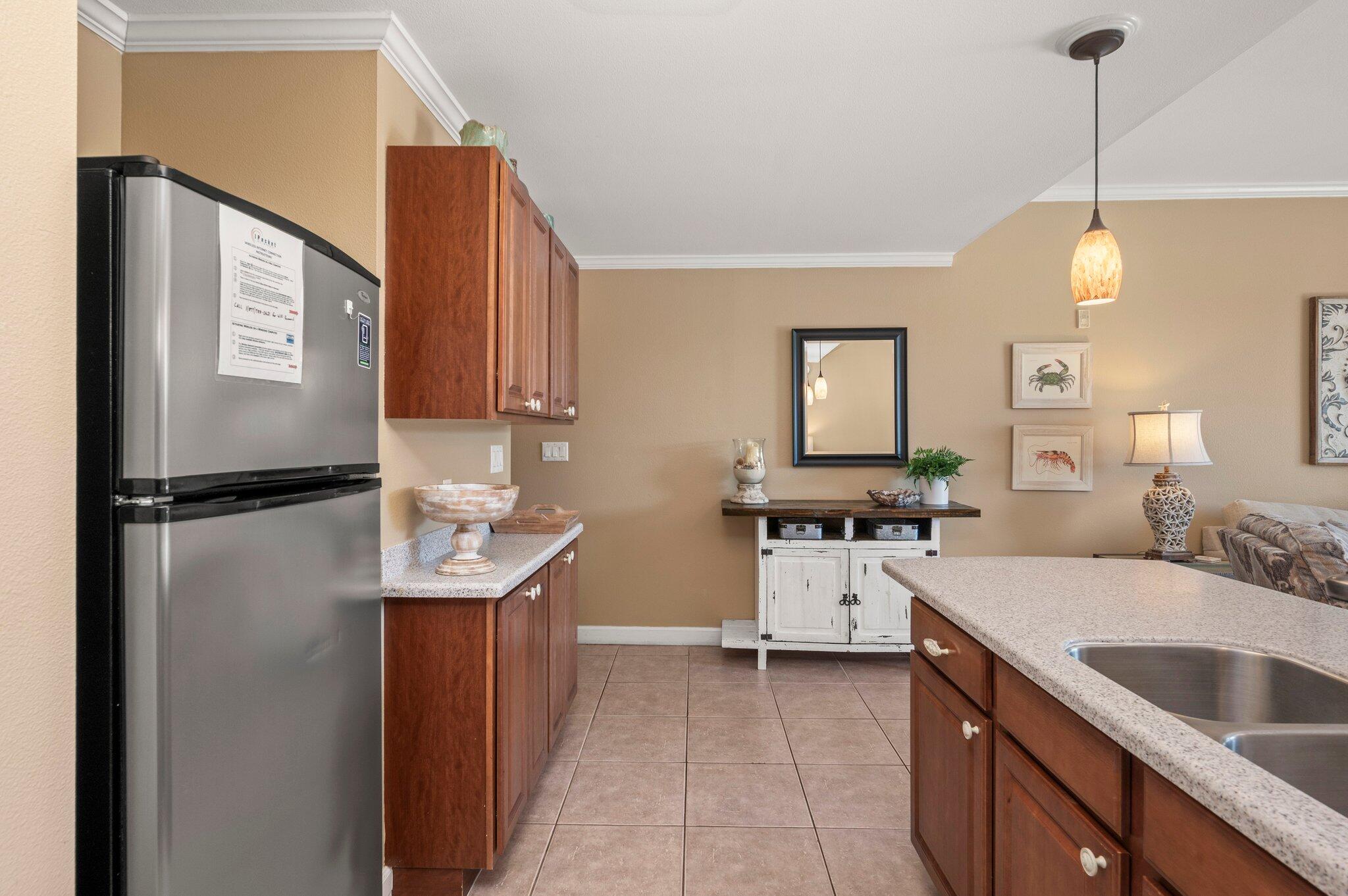 548 Sandy Cay Drive, Unit 203 Miramar Beach, FL 32550 - Photo 37 of 48 a kitchen with a sink refrigerator and cabinets