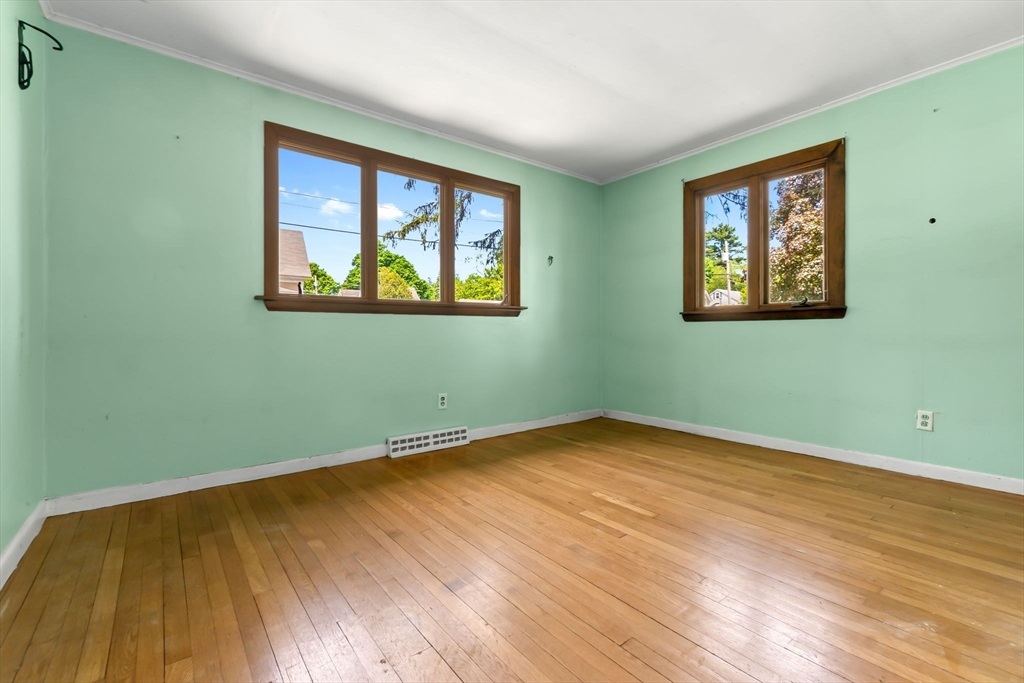 71 Union Street Hamilton, MA 01982 - Photo 14 of 21 a view of an empty room with wooden floor and a window