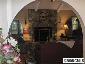 16040 Samoa Court Tega Cay, SC 29708 - Photo 3 of 8 a living room with furniture and a fireplace