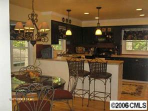 16040 Samoa Court Tega Cay, SC 29708 - Photo 7 of 8 a kitchen with a table and chairs