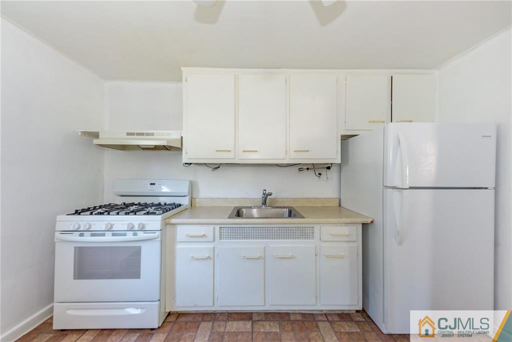 445 Morris Avenue, Unit D5 Springfield, NJ 07081 - Photo 11 of 21 a kitchen with appliances a sink and cabinets