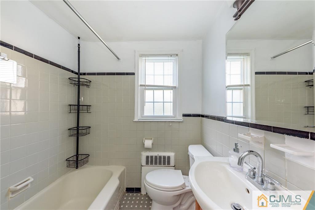 445 Morris Avenue, Unit D5 Springfield, NJ 07081 - Photo 12 of 21 a bathroom with a sink toilet a tub and shower