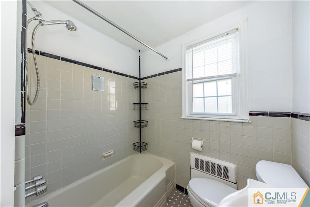 445 Morris Avenue, Unit D5 Springfield, NJ 07081 - Photo 13 of 21 a bathroom with a bathtub a toilet and a shower