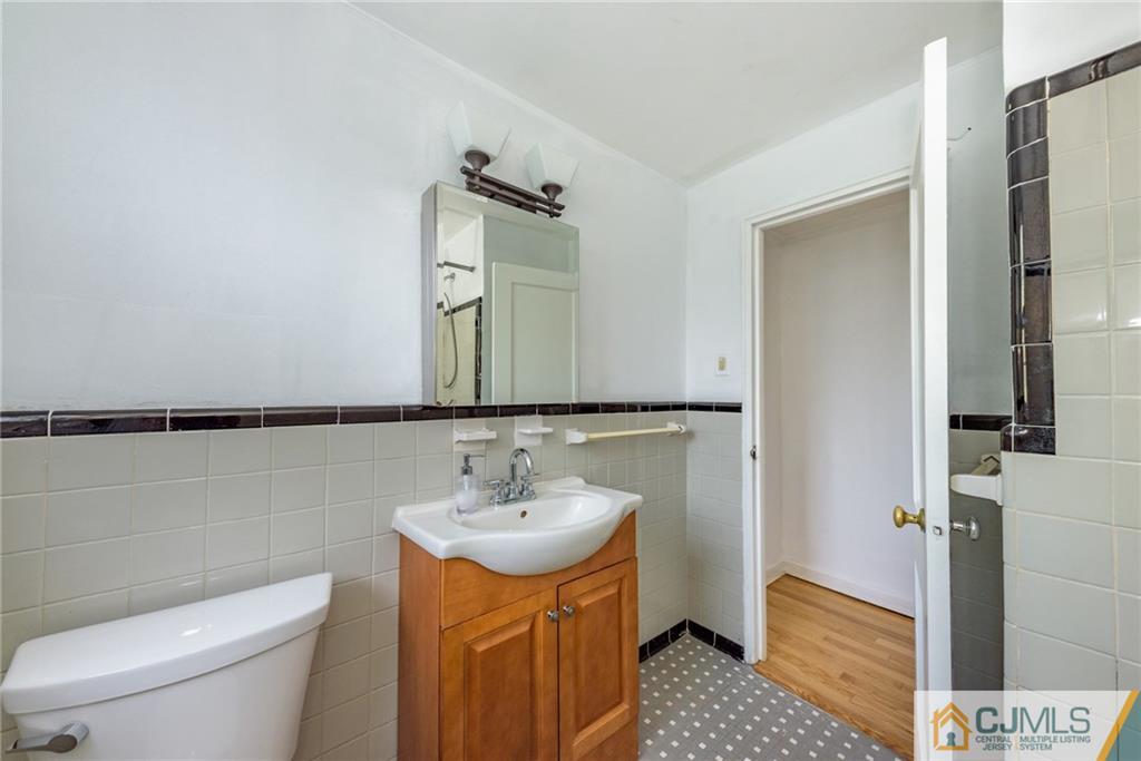 445 Morris Avenue, Unit D5 Springfield, NJ 07081 - Photo 14 of 21 a bathroom with a sink a toilet and shower