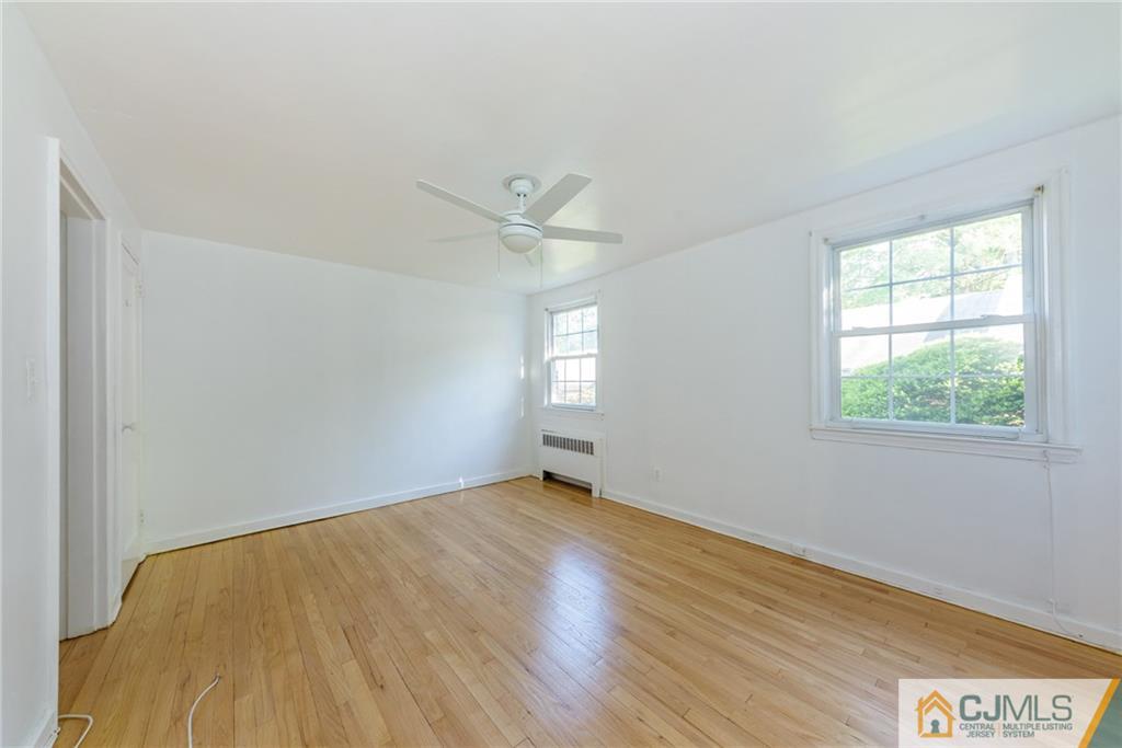 445 Morris Avenue, Unit D5 Springfield, NJ 07081 - Photo 18 of 21 an empty room with wooden floor and windows