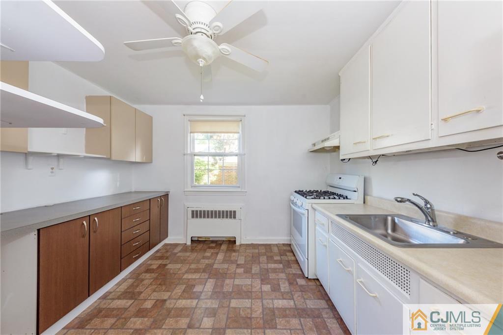 445 Morris Avenue, Unit D5 Springfield, NJ 07081 - Photo 7 of 21 a kitchen with a sink and cabinets