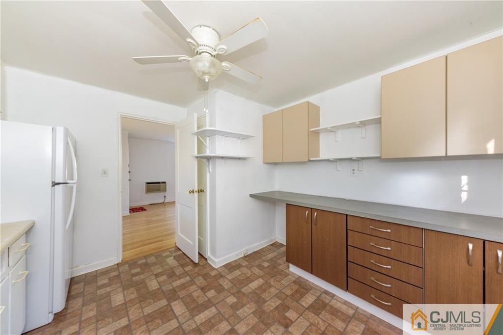 445 Morris Avenue, Unit D5 Springfield, NJ 07081 - Photo 10 of 21 a view of a kitchen with refrigerator and cabinets