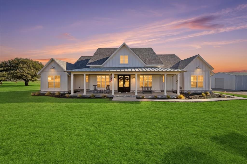 a front view of a house with yard patio and swimming pool
