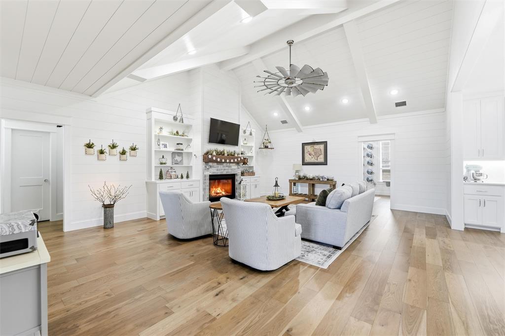 245 La Cresta Lane Perrin, TX 76486 - Photo 5 of 40 a living room with furniture a fireplace and a flat screen tv