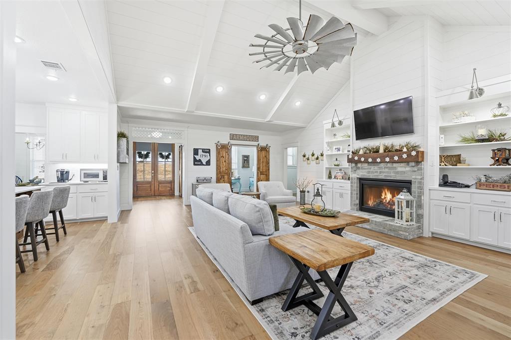 245 La Cresta Lane Perrin, TX 76486 - Photo 7 of 40 a living room with furniture and a fireplace