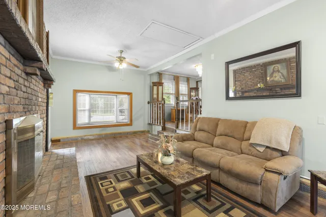 a living room with furniture a dining table and a fireplace