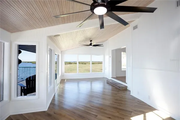 wooden floor in an empty room with a window
