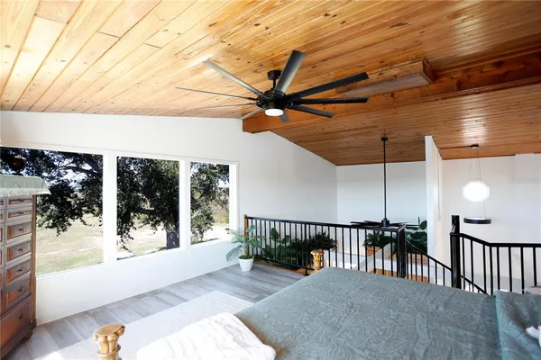 a view of a porch with a floor to ceiling window next to a yard