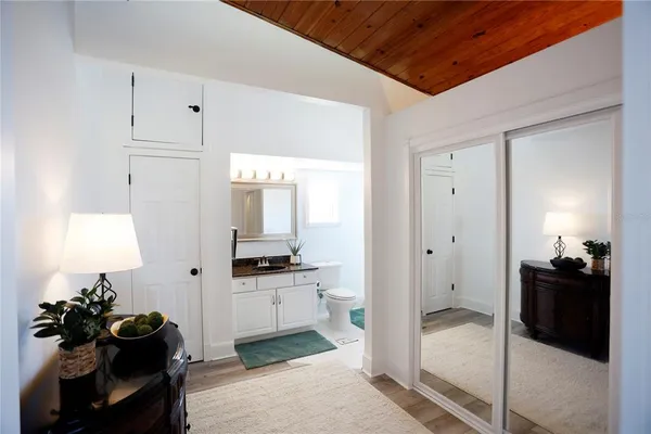 a view of a hallway with workspace and a couch