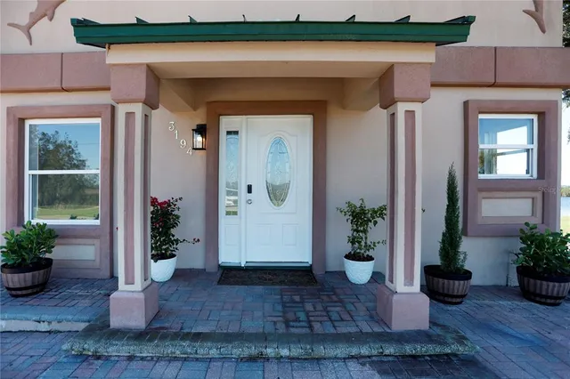 a view of a entryway of the house with potted plants