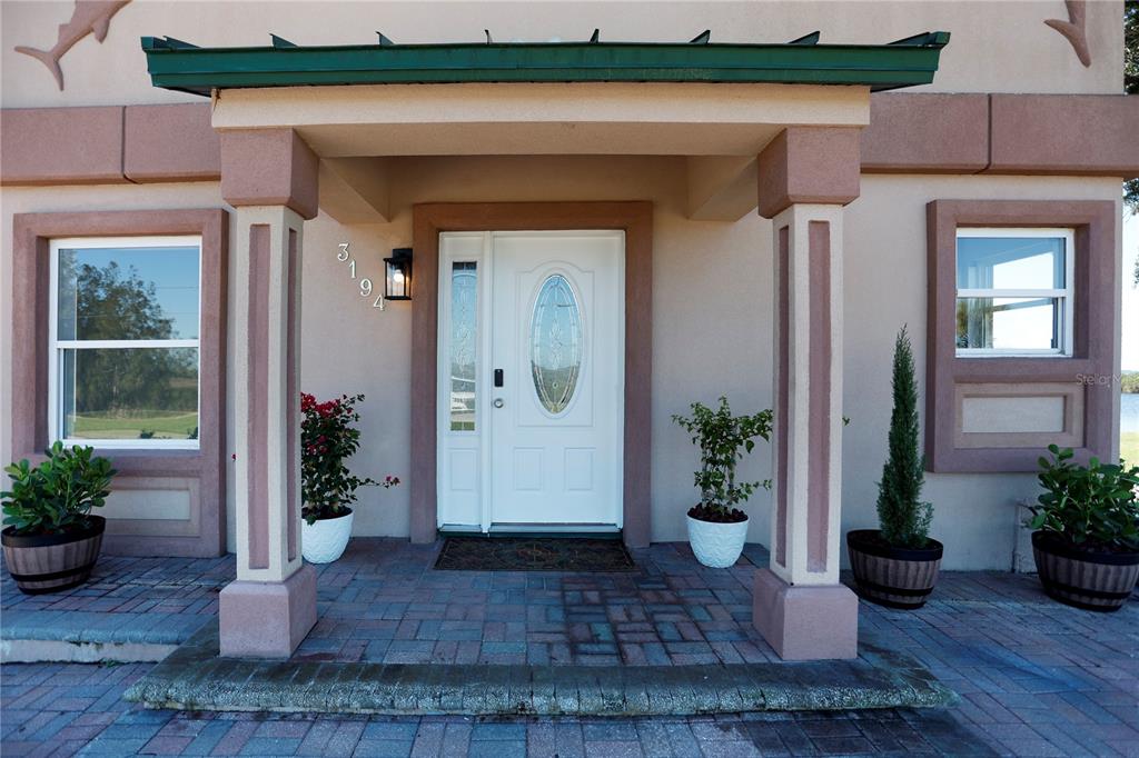 3194 Indian Gulf Lane Spring Hill, FL 34607 - Photo 31 of 38 a view of a entryway of the house with potted plants
